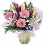 This delightful handtied bouquet in pink, purple and white scented fresh flowers...