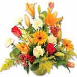 This charming fresh flower arrangement combines yellow, white and red flowers - ...