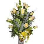 This arrangement consists of 12 yellow roses accompanied by eucalyptus leaves in...