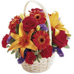 A colourful flower arrangement in a dish/in a basket. ...