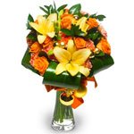 A round bouquet in orange, made with lilies, gerberas & roses, folded aspidistra...