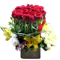 This lovely arrangement with bright 24 wine-red roses, 3 lilies stems & half bun...