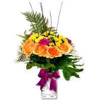 An amazing arrangement of 18 orange flowers and 6 crysontames accented with glos...