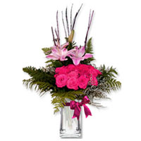Delicate swirls of pink Lilliums - arranged with matching, pink colored 18 roses...