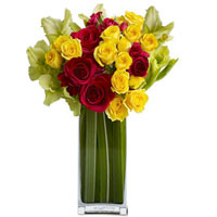 A classy sophisticated bouquet of 9 red and 12 yellow roses holding Lilliums tha...