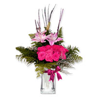 Delicate swirls of pink Lilliums - arranged with matching, pink colored 18 roses...