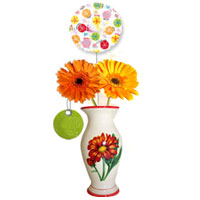 Two gorgious spring Gerberas in a vase (20cm) with an extra stick balloon...
