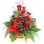 Beautiful red roses arranged into a Gold box with gold and red trim. The gift bo...