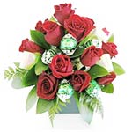 A fun flower arrangement. This cutie contains red roses and delicious Lindt choc...