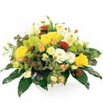 Beautiful basket of mixed seasonal flowers mostly in yellow and white colours (t...