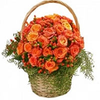 this basket filled with orange roses , hypericum in decoration of red berries an...
