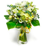 A round bouquet in white, made with tulips, roses and various accompanying flowe...
