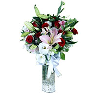 Pink Lilies and Roses in a vase. In this bouquet is composed of 9 red roses with...