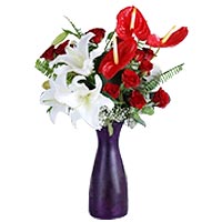 Cylinder glass vase in the red anthurium, white lilies and red roses. 12 Red ros...