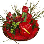 An ambudence of flowers in red and greens makes a cheerful statement. This delic...