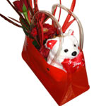 Surprise someone special with red flowers and teddy delivered in a stylish conte...