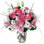 This arrangement of stargazer lilies, pink roses a...