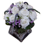 Send this arrangement of purple flowers and  white...
