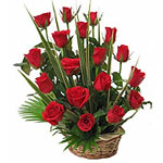 A beautiful arrangement of 18 red Roses with green foliage in a rustic basket....