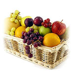 A gorgeous wicker fruit basket containing ripe fru...