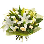 This simple and elegant, monochromatic flower bouquet is made of lilies, lisiant...