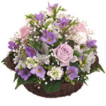 A beautiful pink, purple and white basket arrangement made up of charming roses,...