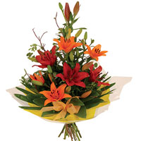 Charming Presentation of Orange Lilies with Palm and Magnolia Leaves