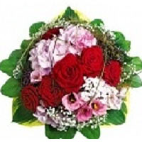 A beautiful bouquet of flowers in pink and red with red roses, pink hydrangeas a...