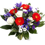 A stand-out grouping of bright red Gerberas, deep blue irises and white roses pa...