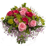 Eye popping pink passion! Multi-toned pink roses offset with small, light purple...
