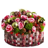 Snow-Covered red roses and New Year ornaments in Basket...