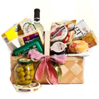 A gift basket includes white wine, different kinds...
