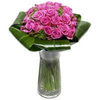 A stunning compact arrangement of classic pink roses and folded leaves....