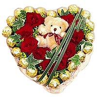 Roses and chocolates in heart shape with bear