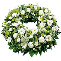 Funeral wreath with all flowers in white flowers filled with greenery...