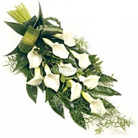 Beautifull and white bouquet with callas and holland greenry....