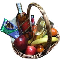 Basket with whisky, fruits