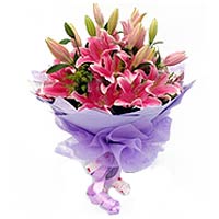 7 pink lilies, with greens, light purple package  ...