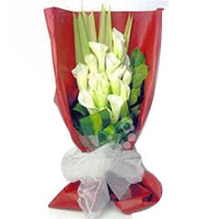 10 white callas, match greenery. Red crepe-paper single-side pack, white gauze b...