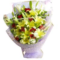 3 white Easter lilies, 8 yellow lilies, 9 red roses, match greenery, purple crep...