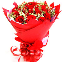 22 red roses with greens, hot red package and beau...