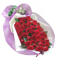 36 red roses, match greenery, white paper wrap ins...