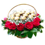 12 red roses,16 chocolates,green leaves arranged i...