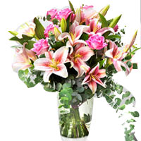  A bouquet of pink roses and lilies adorned with d...