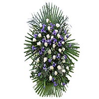 A wreath of white roses and iris show their respect for the deceased person. ...