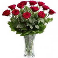 Roses are the perfect gift for all seasons. A spray of twelve long-stemmed red r...