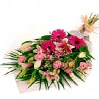 A selection of Pink flowers with the addition of an attractive wrapping paper. I...