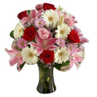 This charming mixture of flowers, including lilies, gerbera daisies and roses is...