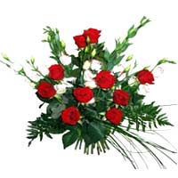 Arrangement of 10 red roses, delicately complements 7 eustom and green garnish...