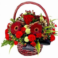 Basket with red roses, gerberas red, hypericum, feel green chrysanthemum and var...